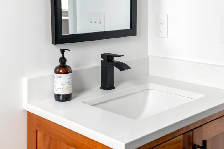 dornbracht - Stylish bathroom setup featuring a sleek black faucet, wall mirror, and elegant counter